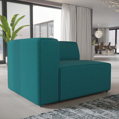 Teal fabric modular sofa block with squared arms in a bright modern living room with large windows.