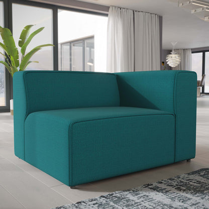 Teal fabric right-facing modular sofa with boxy arms and thick cushions in a bright modern living room.