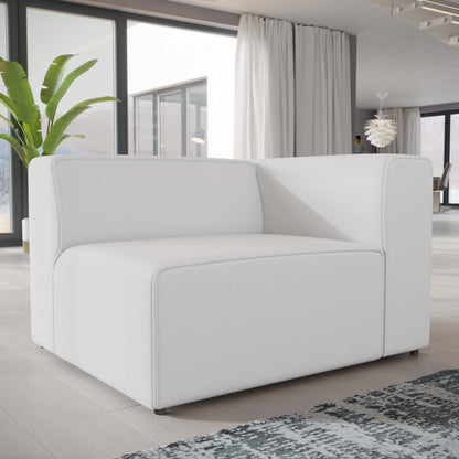 White modular sofa with square arms in a bright modern living room, large windows, light wood floors and a green plant.