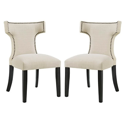 Beige upholstered dining chairs with curved backs and nailhead trim, dark wood legs, set of two