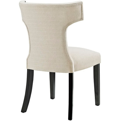 Beige upholstered dining chair with curved back and dark wood legs.