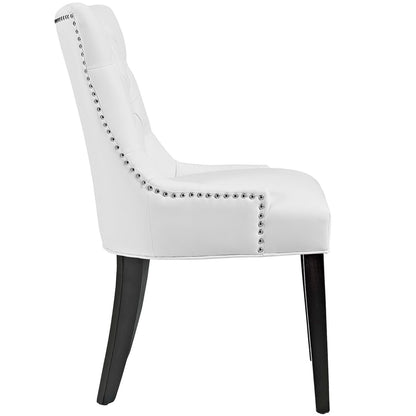 White faux-leather accent chair with silver nailhead trim, high curved back, & dark wood tapered legs.
