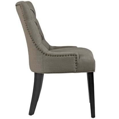 Gray upholstered dining side chair with nailhead trim along edges, curved back & dark wood legs.