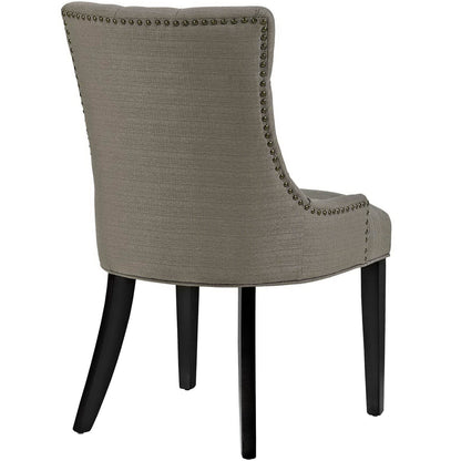 Pair of grey fabric dining side chairs with curved backs, nailhead trim along the edges, and dark wood legs.