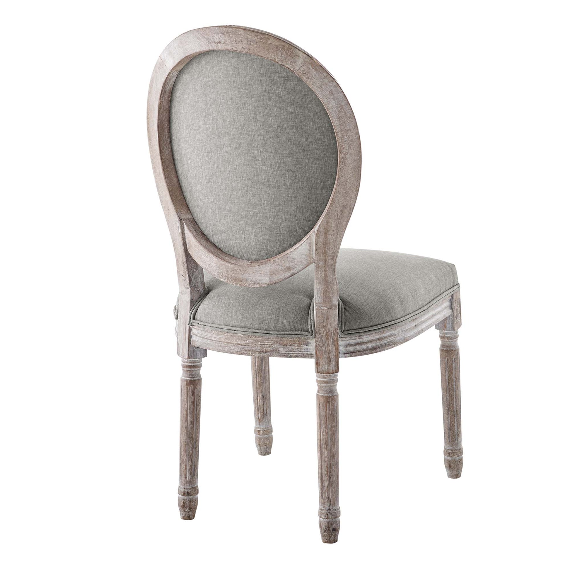 Distressed gray wood dining side chair with an oval upholstered back and cushioned seat in light gray fabric.