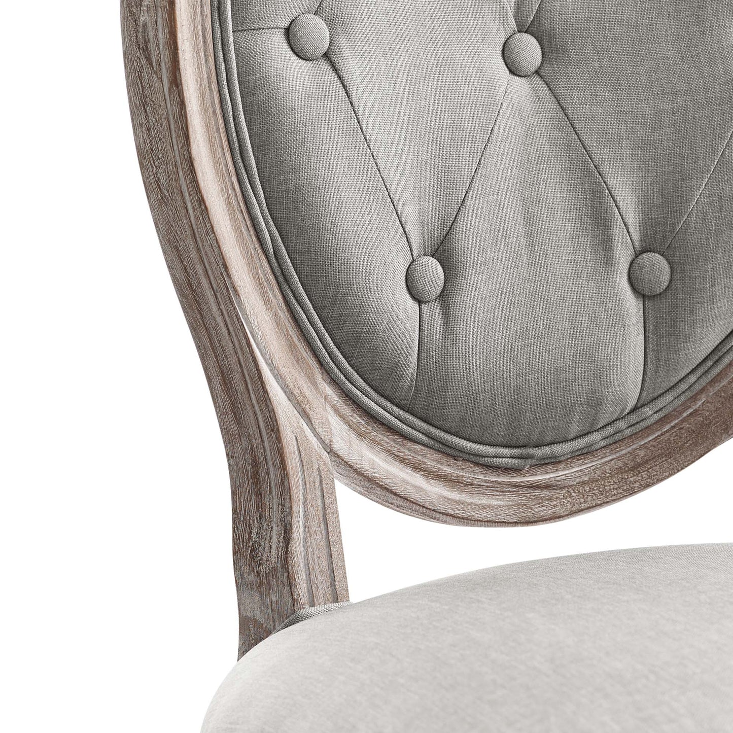 Light gray tufted fabric dining side chair with a curved wooden frame and button detailing.