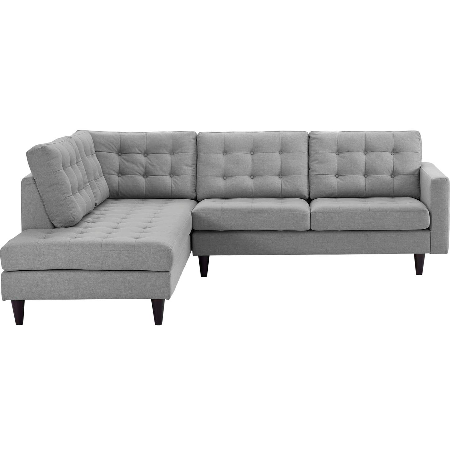 Light gray fabric L-shaped sectional sofa with tufted back cushions and a left chaise, tapered dark wood legs.