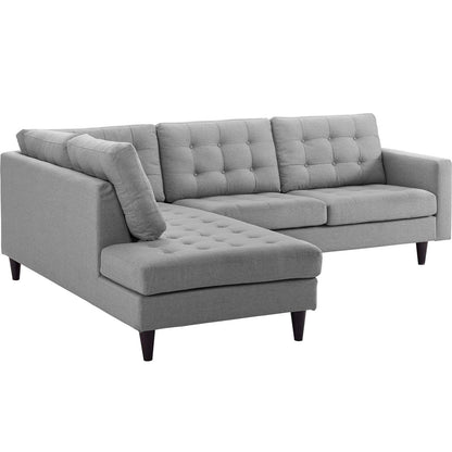 Grey fabric L-shaped sectional sofa with chaise, tufted back cushions and tapered dark wood legs