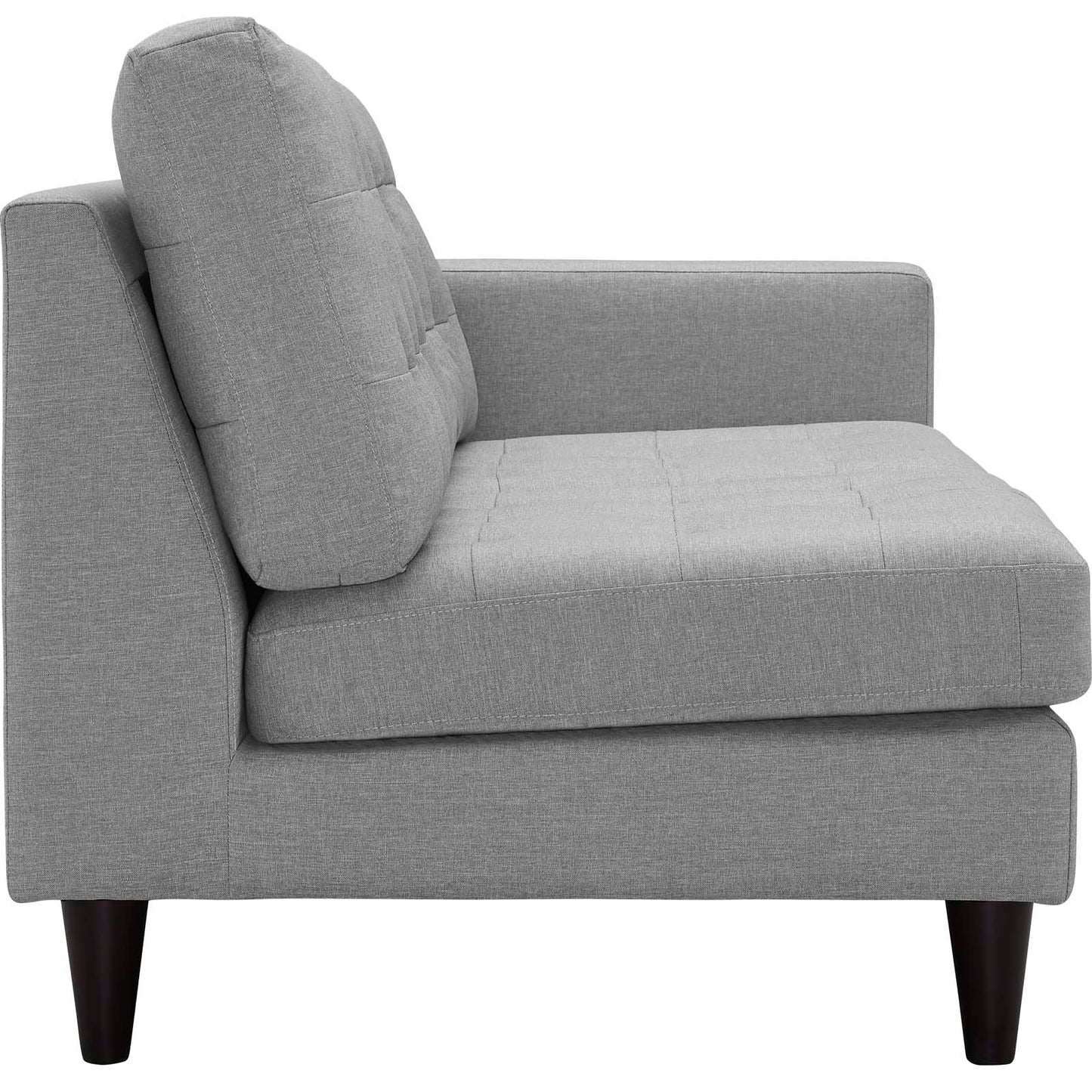 Light gray fabric left-facing bumper sectional with tufted seats, tall back cushions, and tapered dark wood legs.