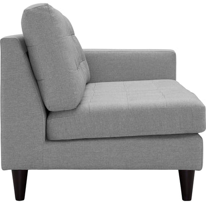 Light gray fabric left-facing bumper sectional with tufted seats, tall back cushions, and tapered dark wood legs.