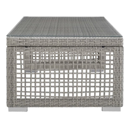 Gray resin wicker outdoor coffee table with square lattice sides.