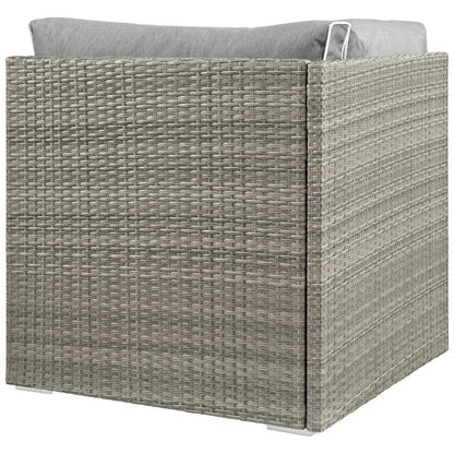 Square gray wicker outdoor patio corner chair with a light gray cushion.
