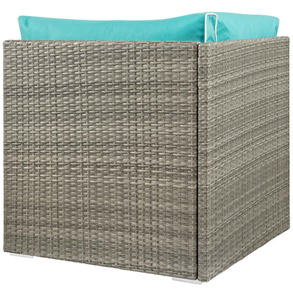 Light gray woven outdoor rattan corner module with turquoise cushions for patio seating.