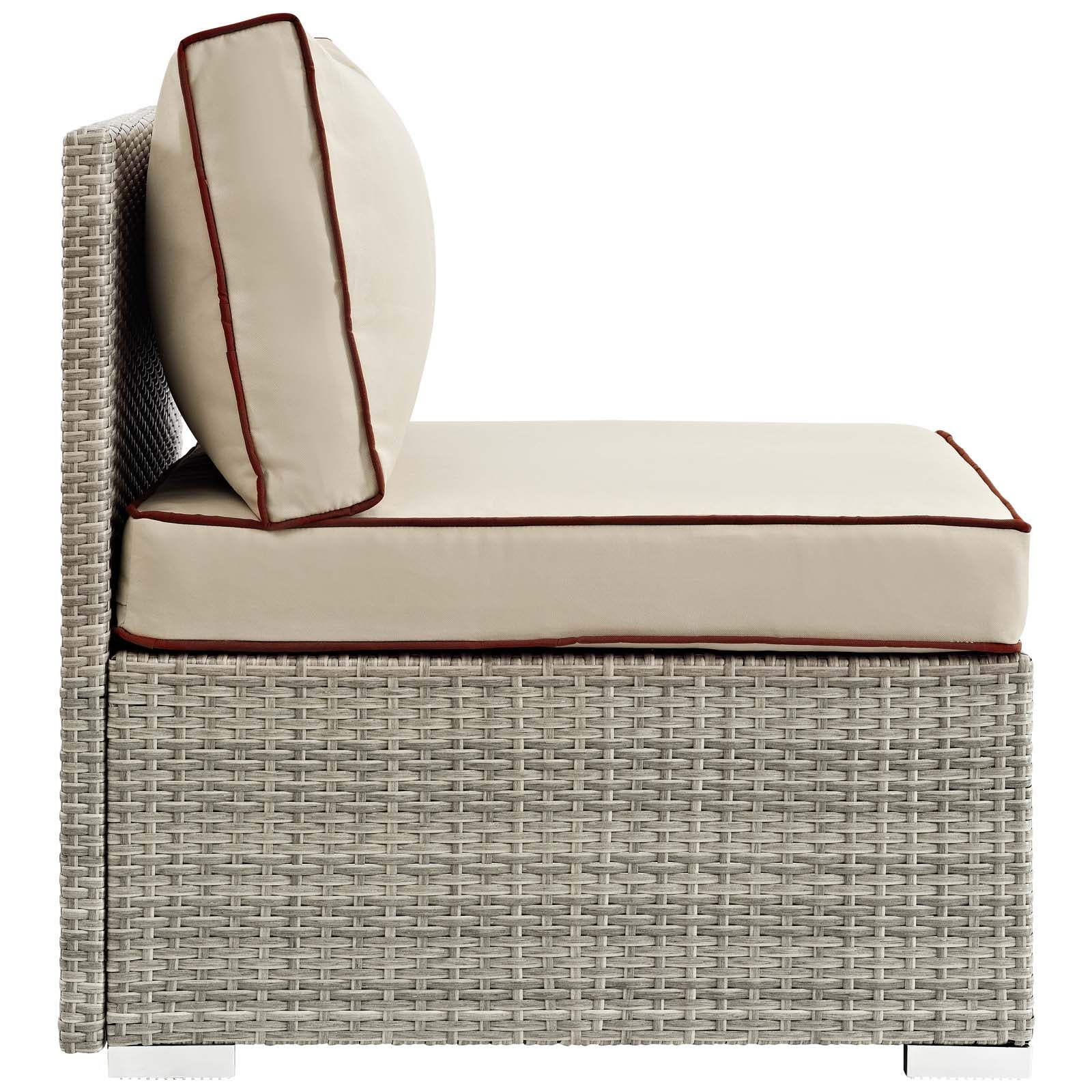 Beige outdoor wicker armless patio chair with burgundy piping and a round bolster pillow.