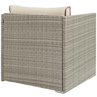 Beige-gray outdoor patio armchair with a light cream cushion and red piping, square modular rattan-style.