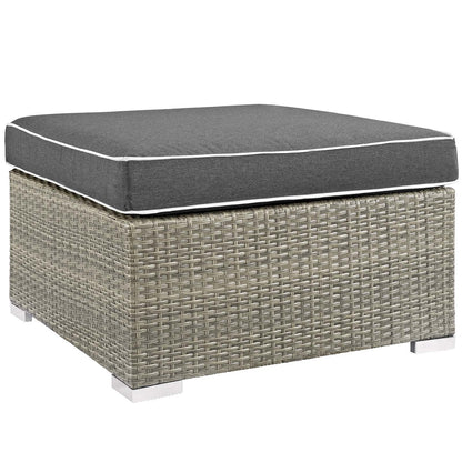 Rectangular outdoor upholstered fabric ottoman with charcoal cushion.