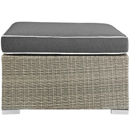 Outdoor fabric ottoman with light gray charcoal upholstery and white piping