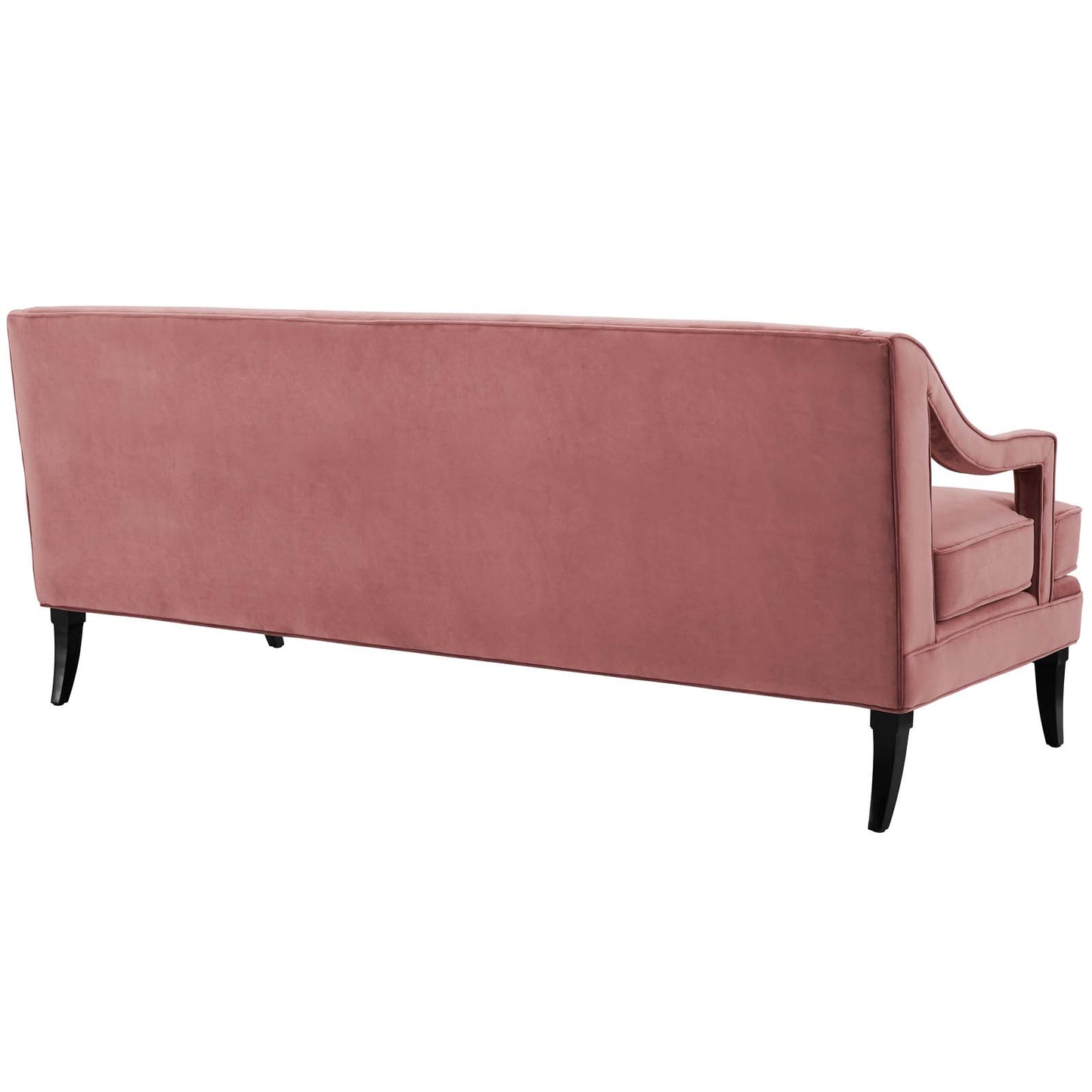 Dusty rose velvet sofa seen from side with curved arms, plush cushions, and black tapered legs.