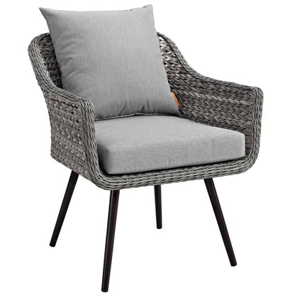 Gray woven rattan outdoor patio armchair with light gray cushions and black tapered legs.