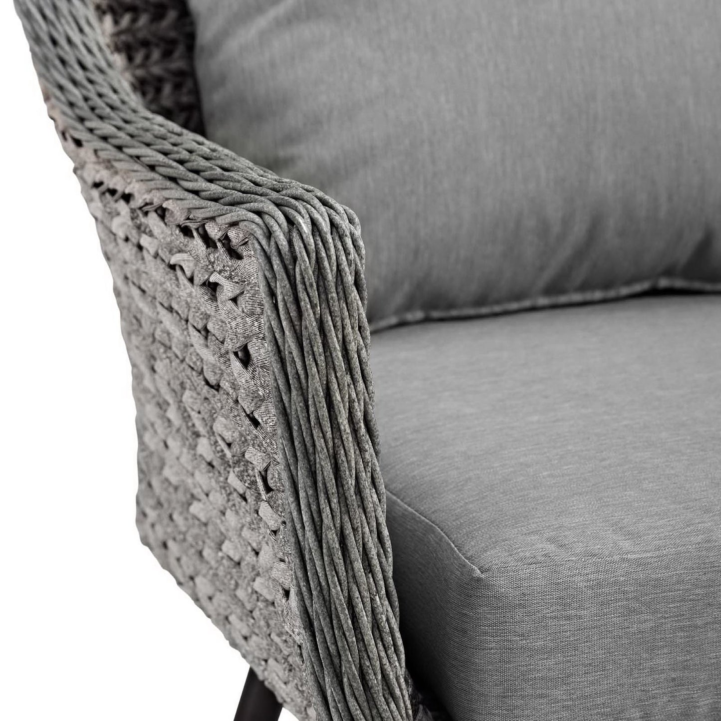 Grey woven wicker armchair with a matching grey cushion, modern outdoor lounge chair.