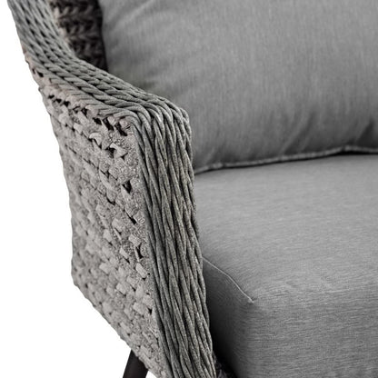Grey woven wicker armchair with a matching grey cushion, modern outdoor lounge chair.