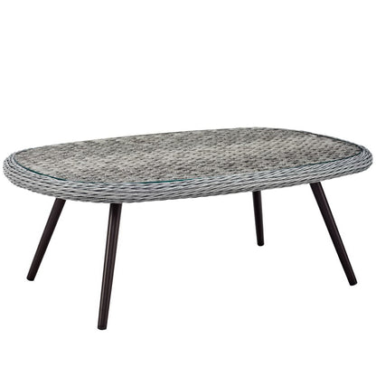 Oval gray rope-wrapped coffee table with glass inset and tapered black legs.
