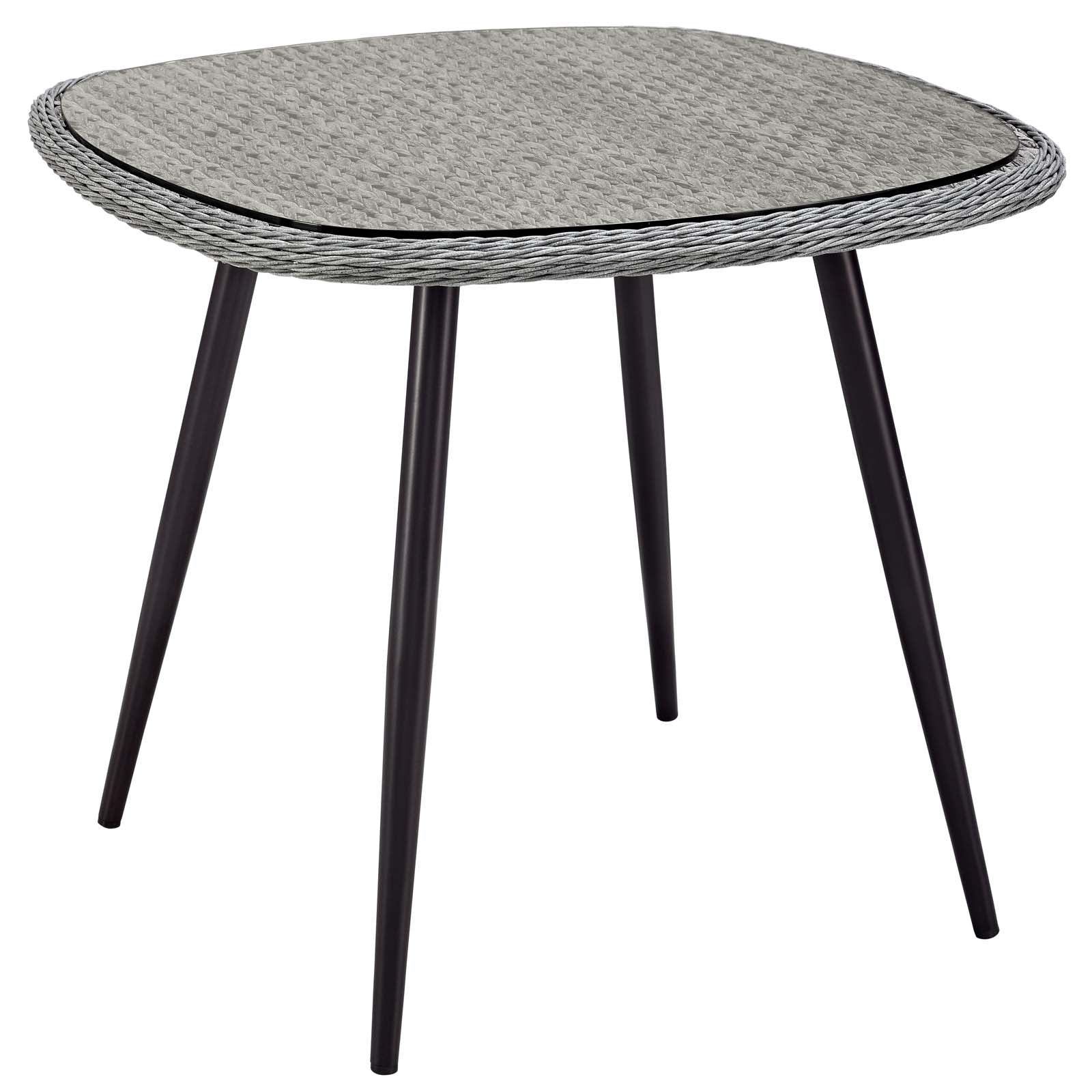 Gray outdoor dining table with a woven wicker top and four black tapered legs; 36 inches.