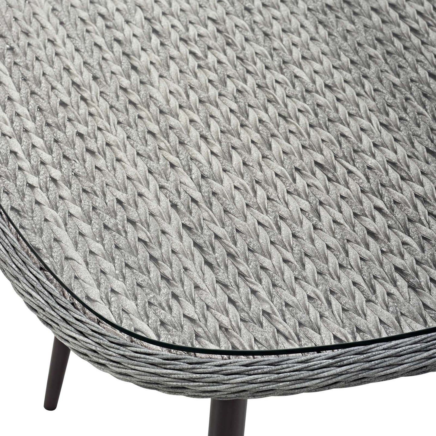 Round gray woven wicker dining table with black edge trim and dark legs.
