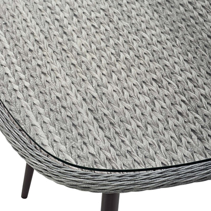 Round gray woven wicker dining table with black edge trim and dark legs.