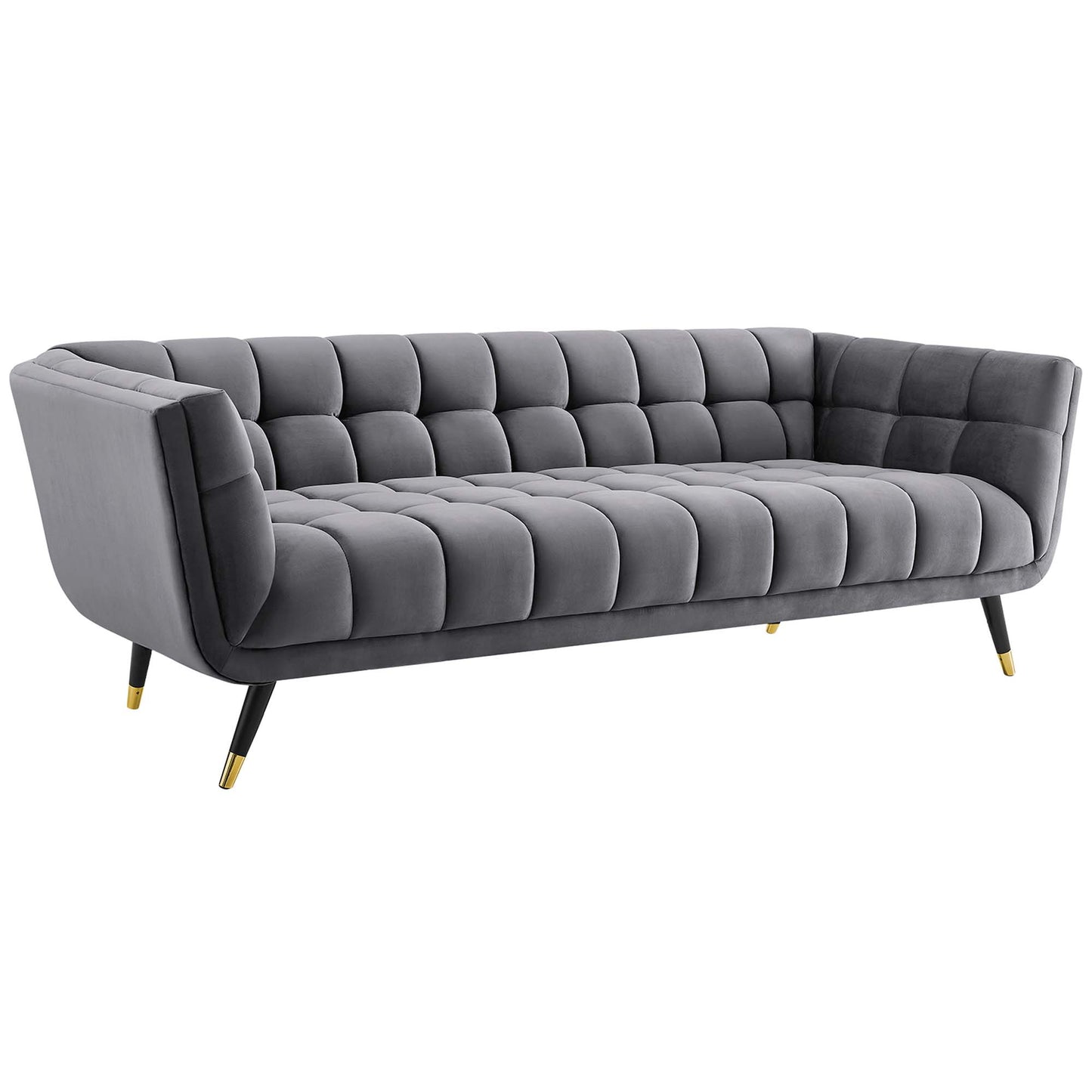 Gray velvet tufted sofa with square-grid cushions, curved arms, gold-tipped legs, mid-century style