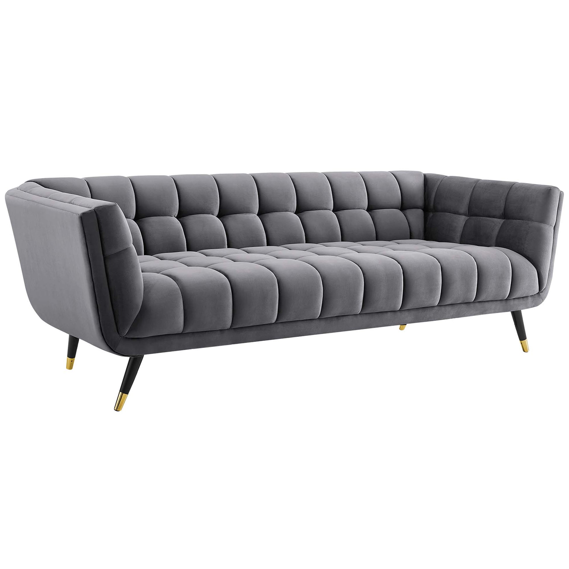 Gray velvet tufted sofa with square-grid cushions, curved arms, gold-tipped legs, mid-century style