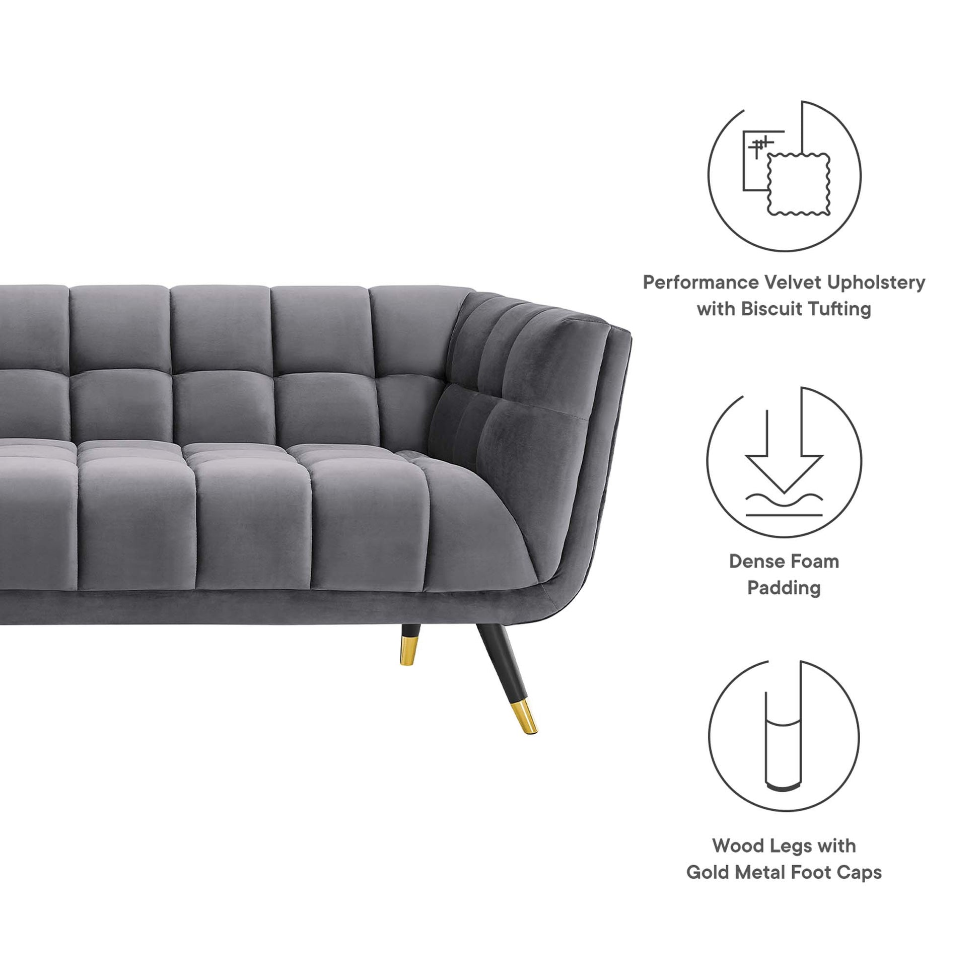 Grey velvet tufted sofa with biscuit tufting, curved silhouette; dense foam padding and wood legs with gold caps.