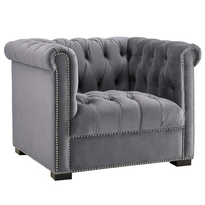 Gray velvet tufted armchair with rolled arms, nailhead trim, and square wooden feet.