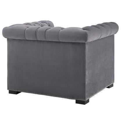 Grey velvet tufted armchair with nailhead trim, square block feet, plush seat, modern living room seating.