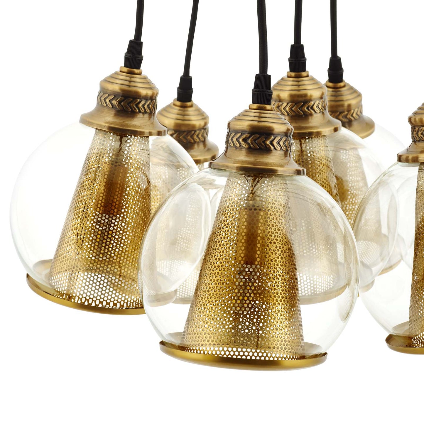 Group of brass pendant lights with clear glass globes and perforated gold inner shades.