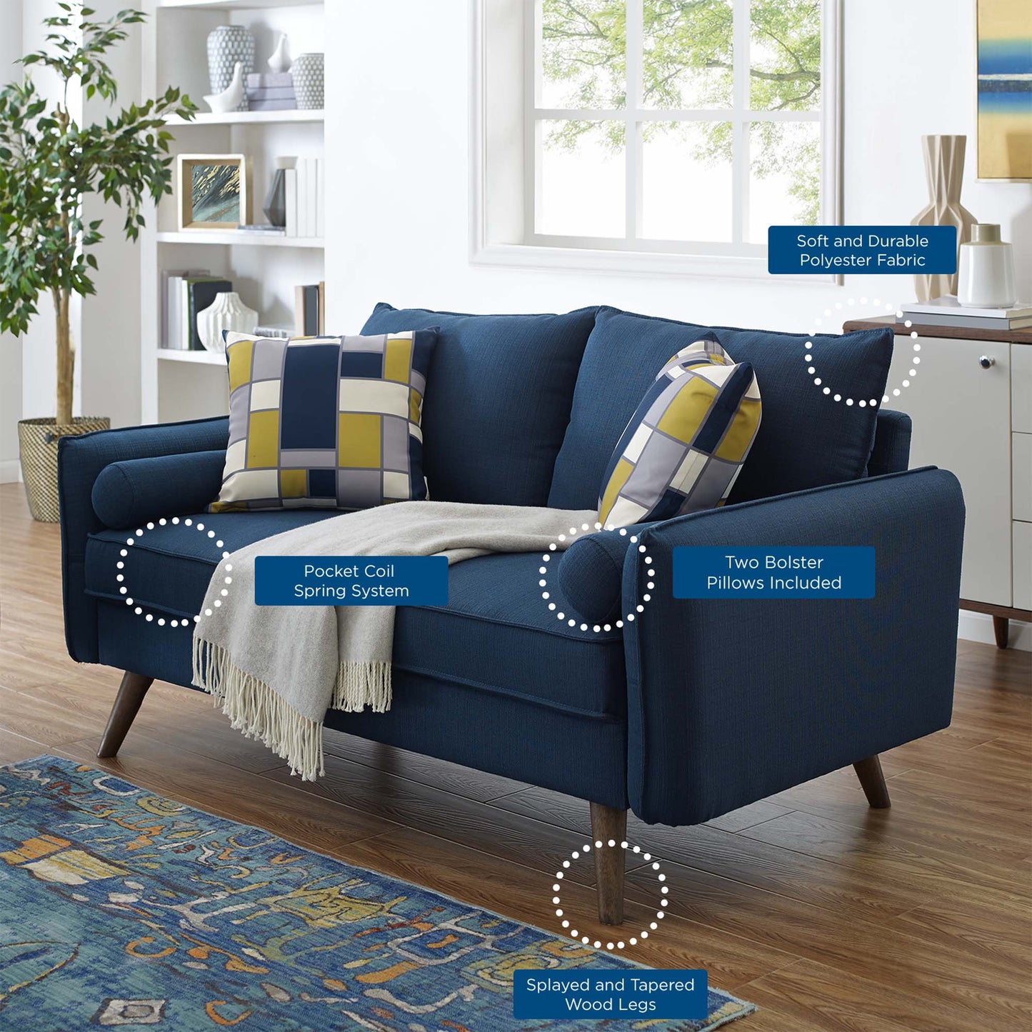 Azure blue loveseat with geometric yellow-gray cushions, beige throw blanket, and tapered wooden legs in a bright living room.