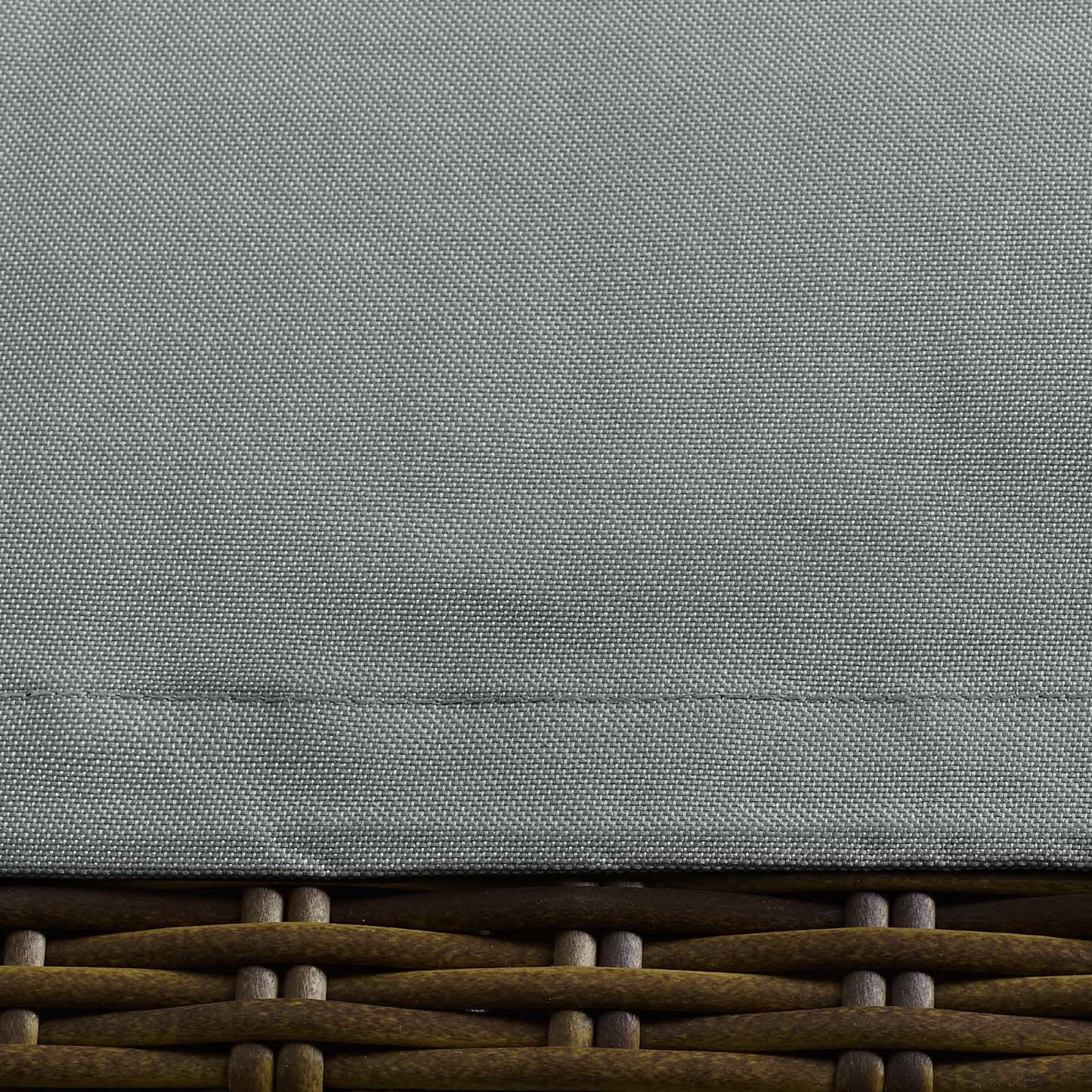 Gray textured fabric lid atop brown woven rattan base; outdoor patio furniture cover.