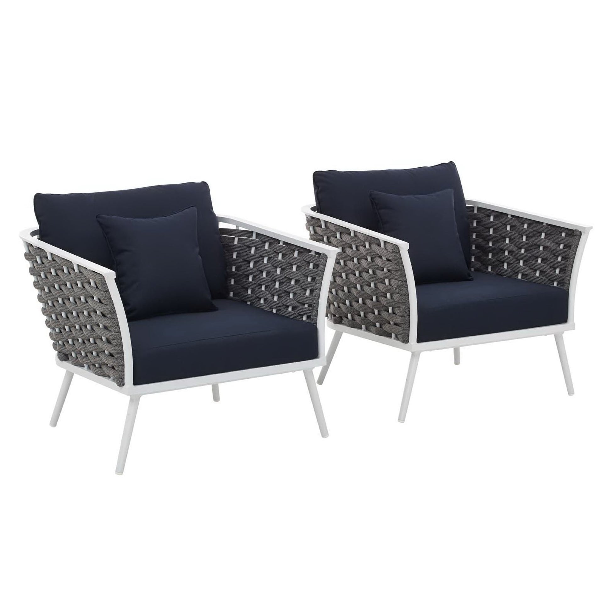 Pair of white aluminum-framed outdoor armchairs with navy cushions and navy throw pillows.