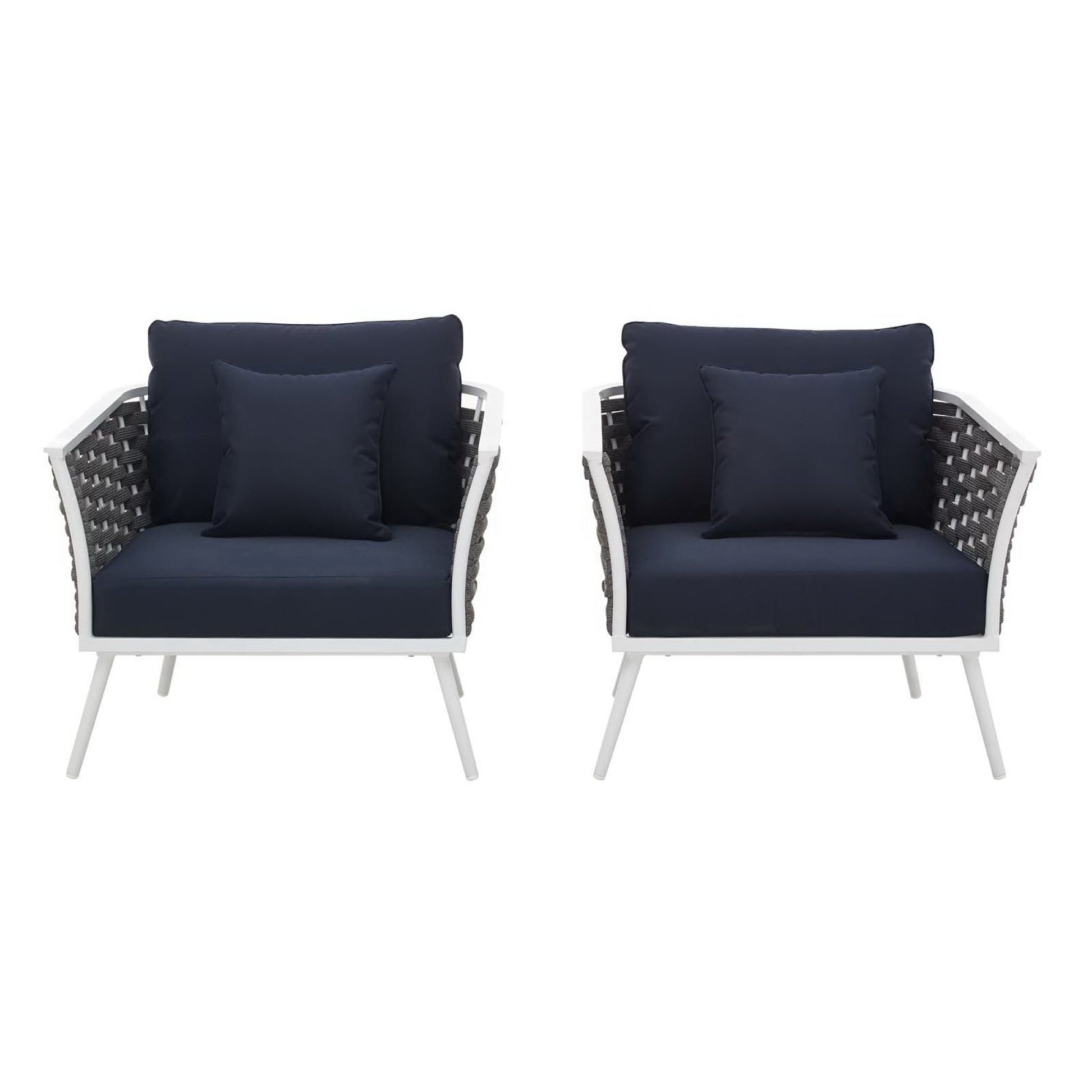 Set of two white outdoor aluminum armchairs with navy cushions and woven dark backs.