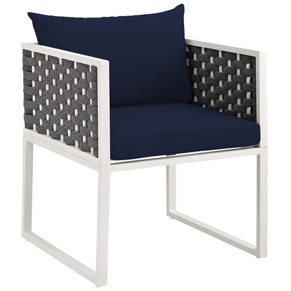 White aluminum-frame outdoor dining set with navy cushions and gray woven side panels.