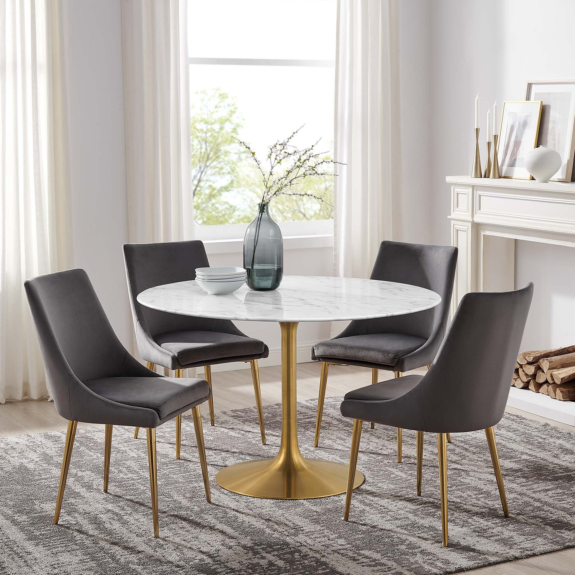 Round faux-marble dining table with a brass pedestal; modern white table.