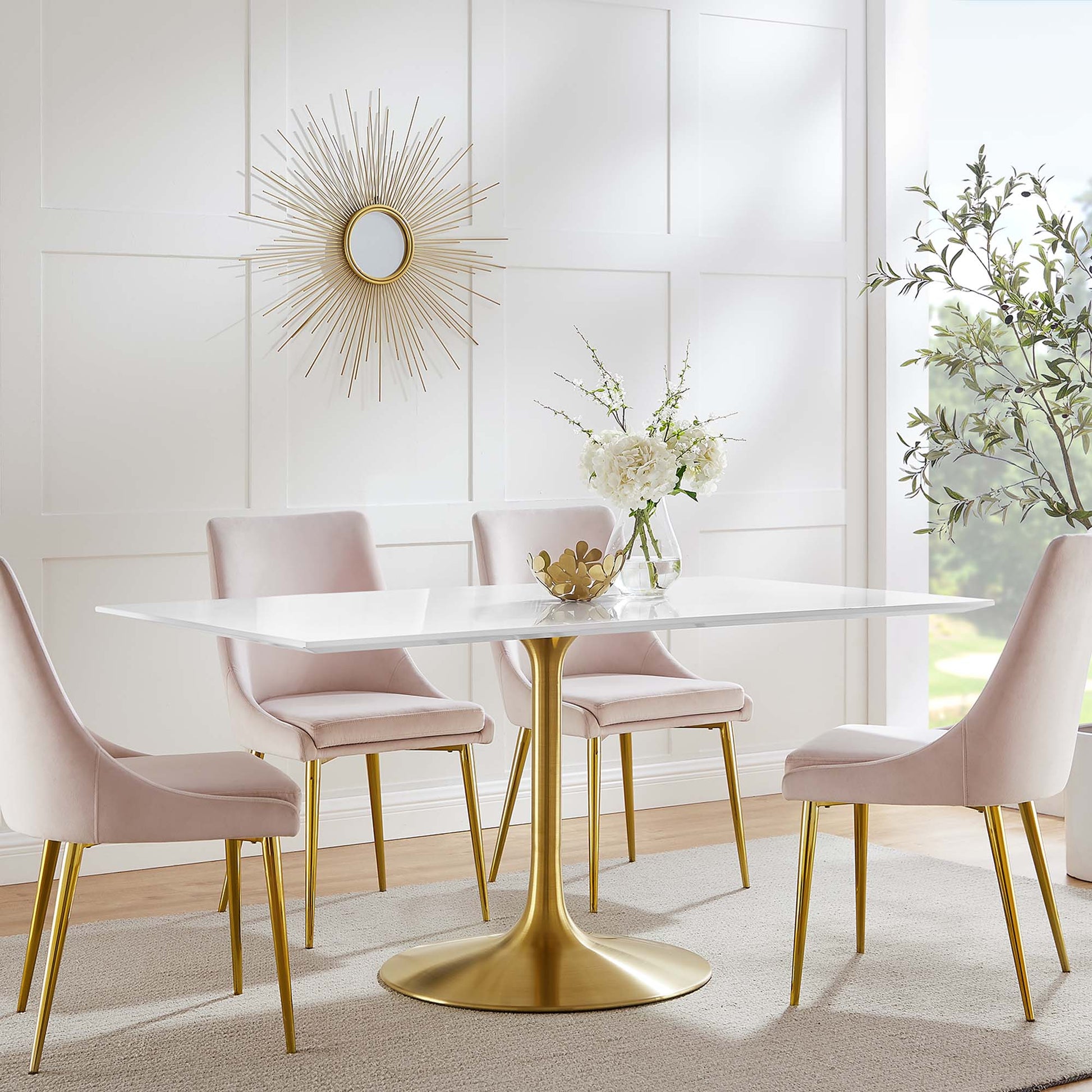 Modern white rectangular wood dining table, 60 inches long, with pink upholstered chairs, a gold sunburst mirror, and a floral centerpiece.