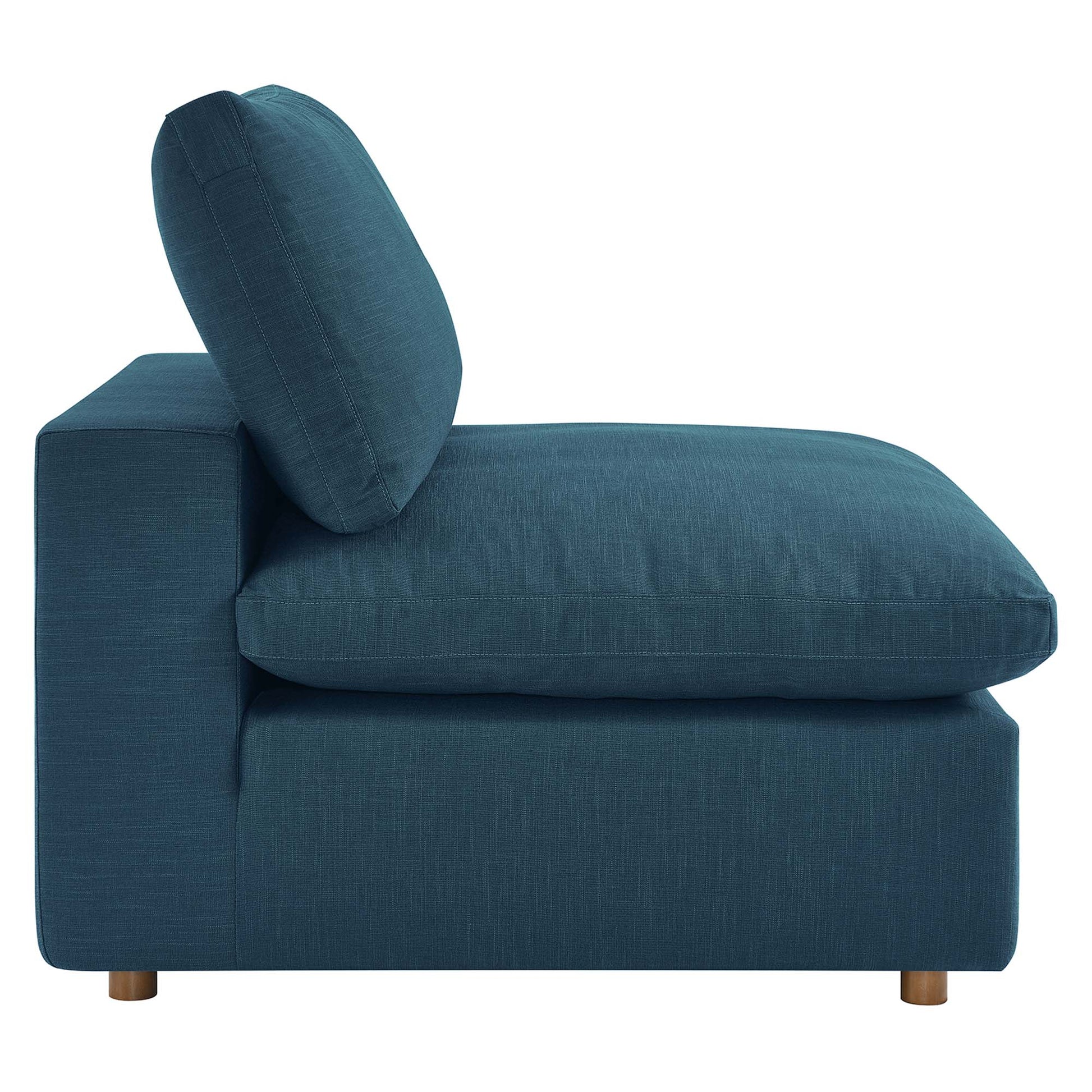 Teal blue fabric armless chair with thick seat cushion and back pillow, low-profile frame and wooden legs.