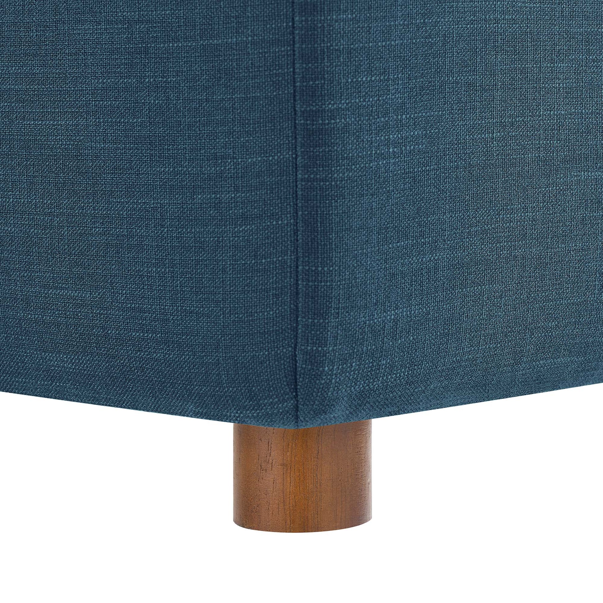Azure blue textured fabric upholstery on an armless chair with short cylindrical wooden legs.