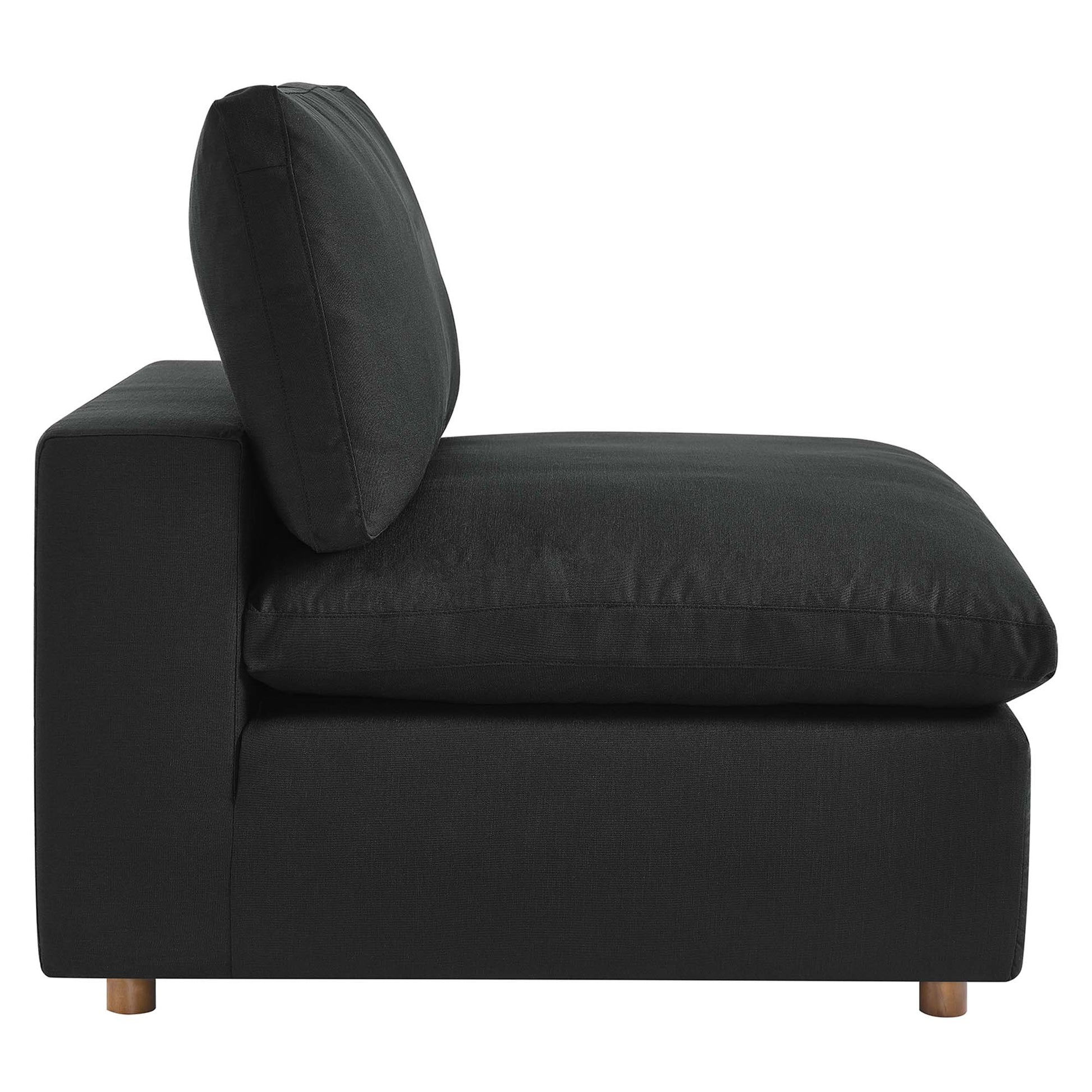 Black fabric armless chair with a single back cushion, down-filled and overstuffed, low-profile design and wooden legs.