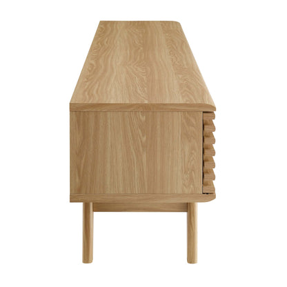 Natural oak TV stand / entertainment center with smooth top, flush front, right-side slatted panel; raised tapered legs, mid-century style.