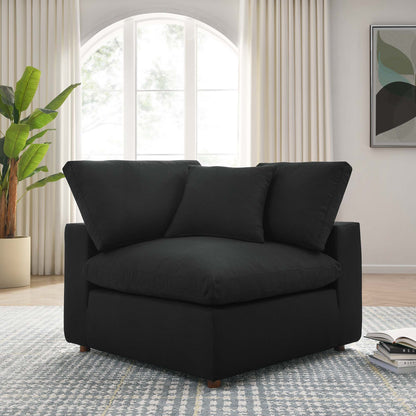 Black fabric upholstered corner chair with two back cushions and square arms, modern living room seating.