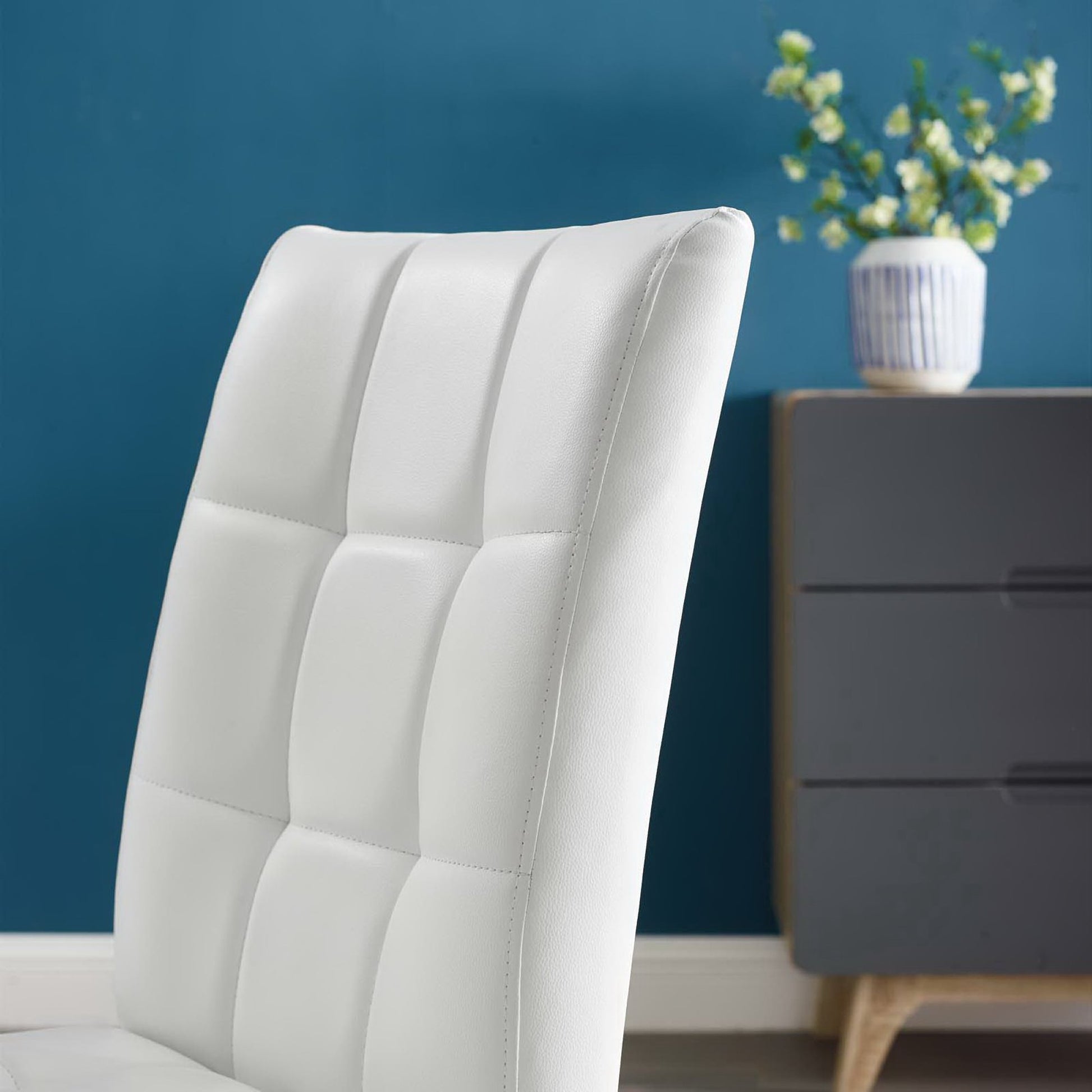 White tufted high-back dining chairs (set of 2) with square panel upholstery; modern, living-room style against a blue wall.