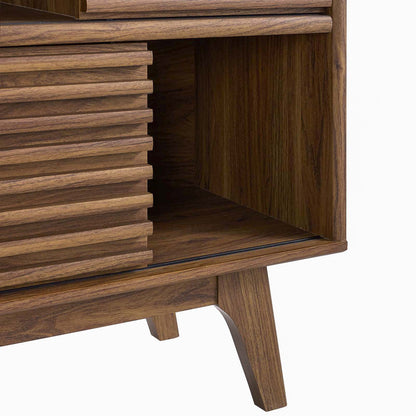 Walnut mid-century cabinet with slatted tambour door, open cubby, and tapered legs.
