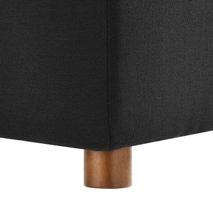 Black fabric upholstered sectional sofa corner with a short natural wood cylindrical leg.